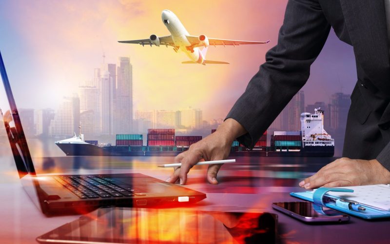 businessman working with Container Cargo ship and Cargo plane with big city  in seaport , logistic import export background and transport industry.